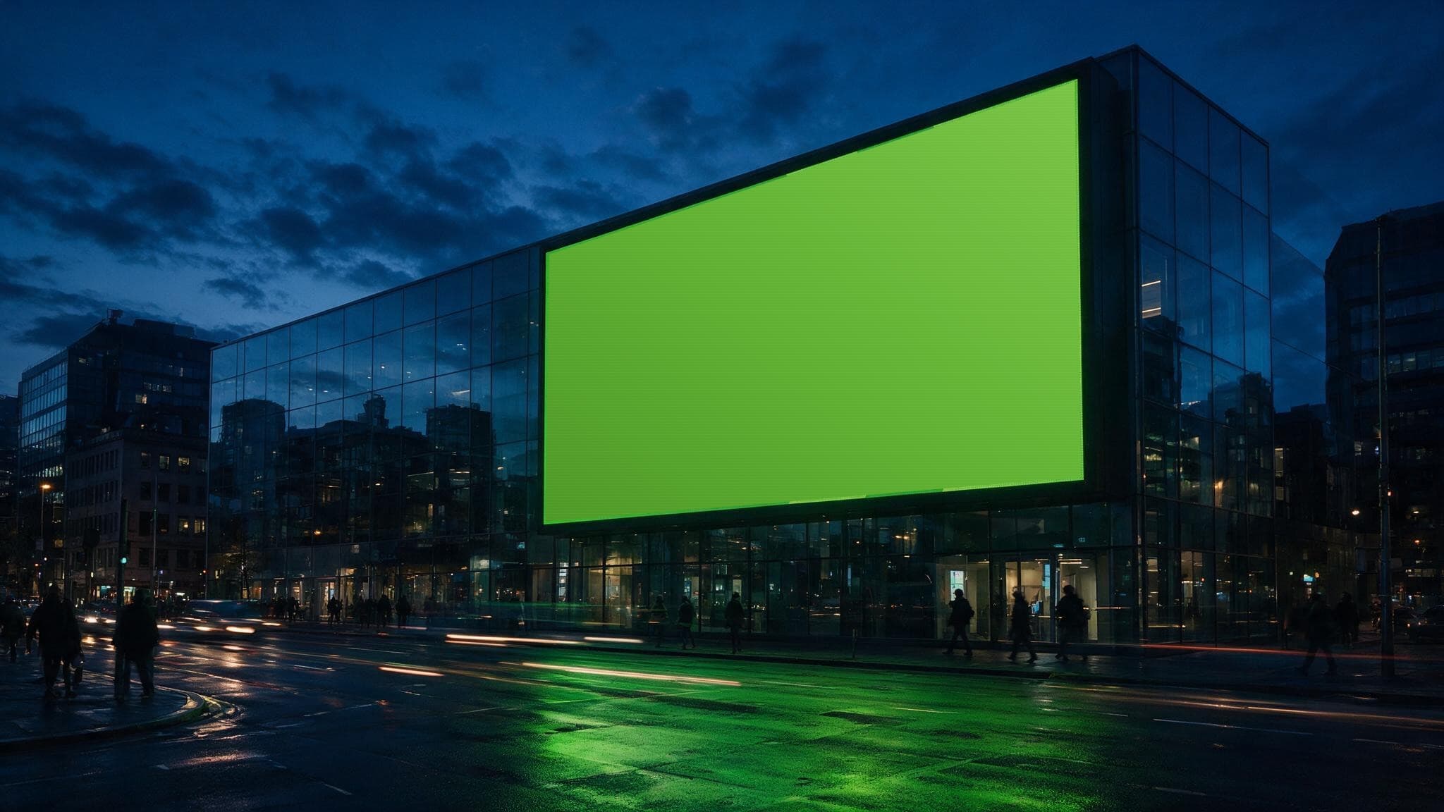 A city-scale digital billboard at dusk, lit in Totally Charged brand green